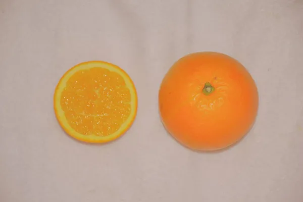orange and yellow fruit on a white background