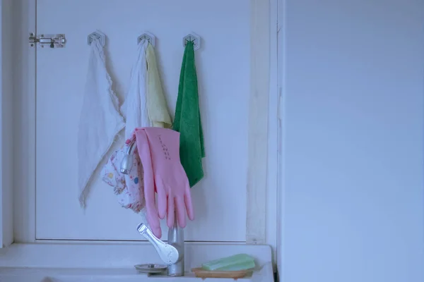 woman cleaning room with a white wall