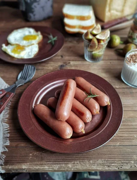 sausages with bacon and sausage on a wooden background