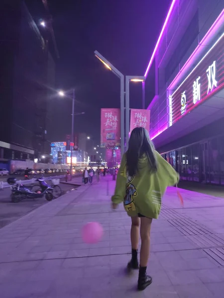 young woman in a night city