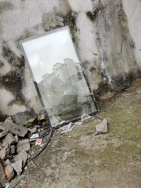 concrete wall with a broken glass and a window