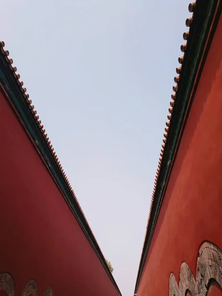 red and white paper sheet on the roof of the house