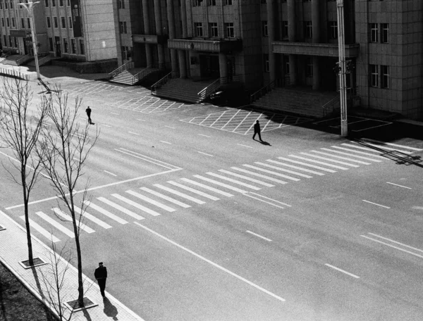 black and white photo of a street in the city