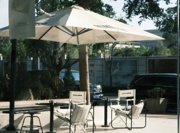 outdoor cafe with umbrella and chairs