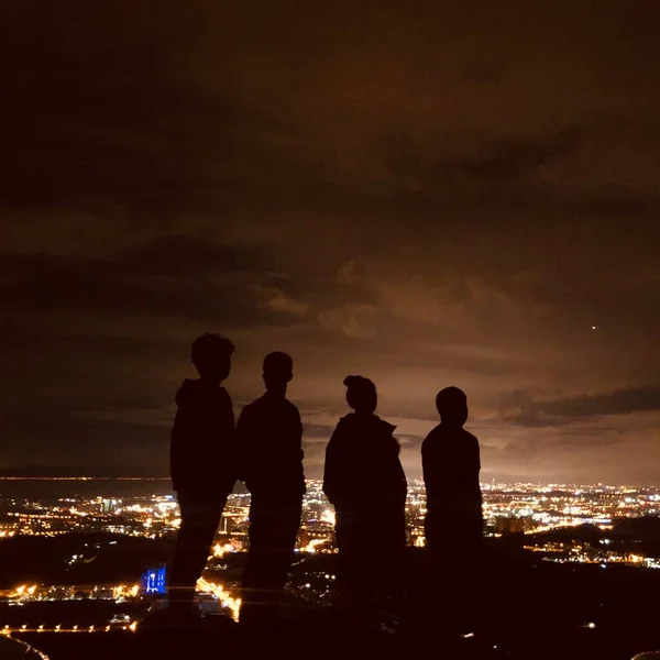 silhouette of a man and woman in a night city