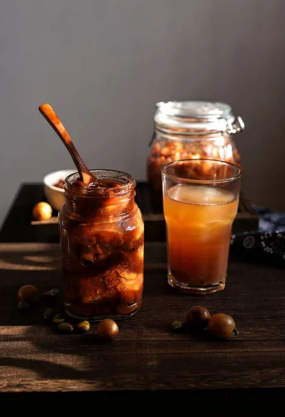 homemade iced coffee with cinnamon and anise on a wooden background. selective focus.