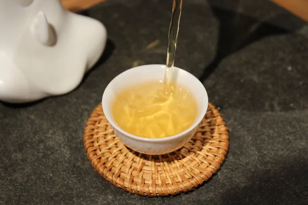 pouring honey in a bowl on a wooden table