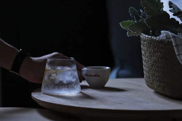 tea cup with a glass of milk and a teapot on a wooden table