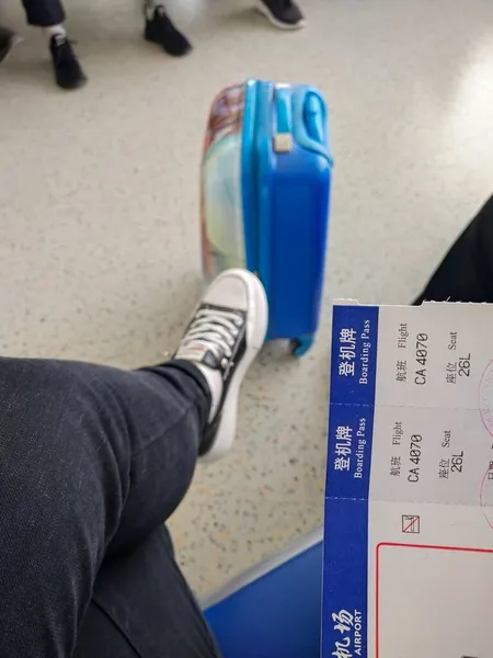 man with luggage bag and boarding pass