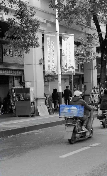 black and white photo of a street in the city