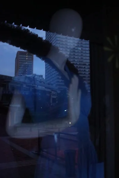 silhouette of a man in a black suit and a white shirt on the roof of the city