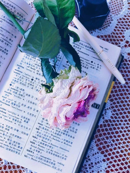 a bouquet of flowers and a book
