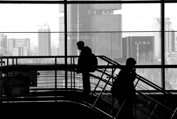 silhouette of a man and woman in a black suit and a white shirt with a backpack on the background