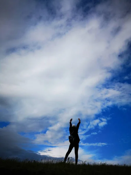 silhouette of a man and woman in the sky