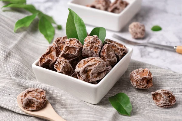 chocolate truffles with nuts and mint on a wooden background