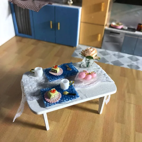 a vertical shot of a white and blue kitchen table with a baby\'s toys