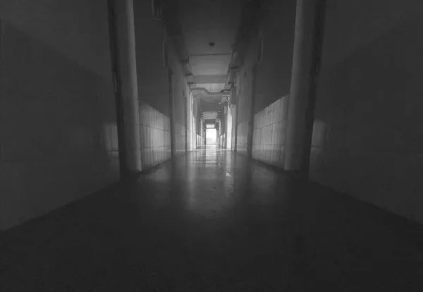 dark corridor with a black and white room