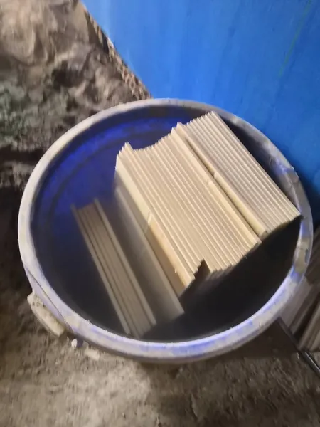 close up of a stack of rolled iron and a pile of paper
