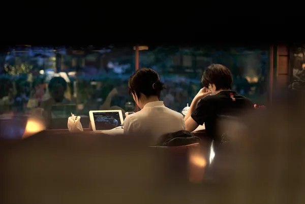 young couple in love sitting on the bench in the night