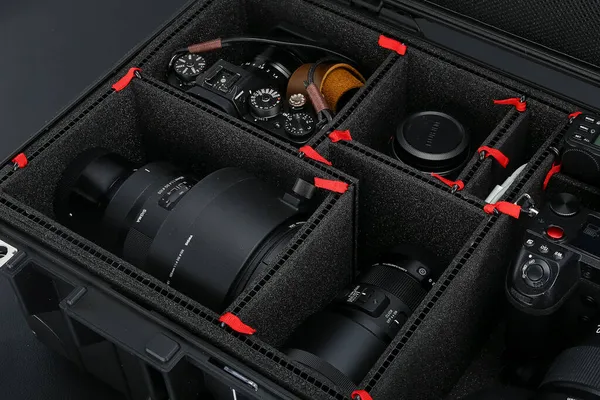 camera and black leather case on a dark background.