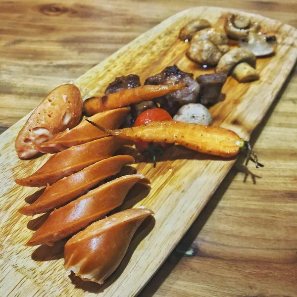 stock image grilled sausages on a wooden board