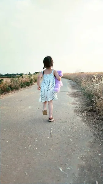 little girl walking in the field