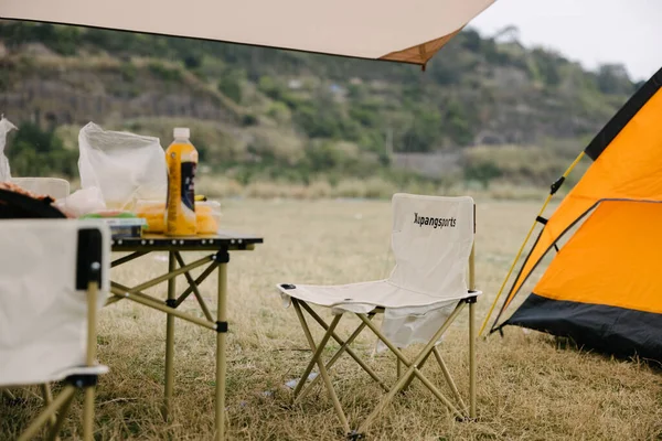 tent with a book and a blanket on the background of the mountains
