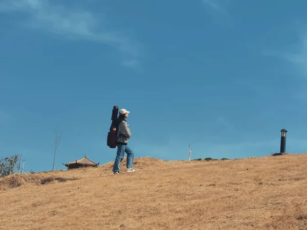 stock image young man with backpack and hiking poles on the mountain