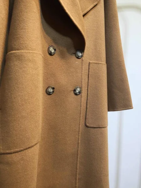 mannequin in a coat on a wooden background