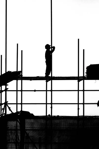 silhouette of construction workers on the building site