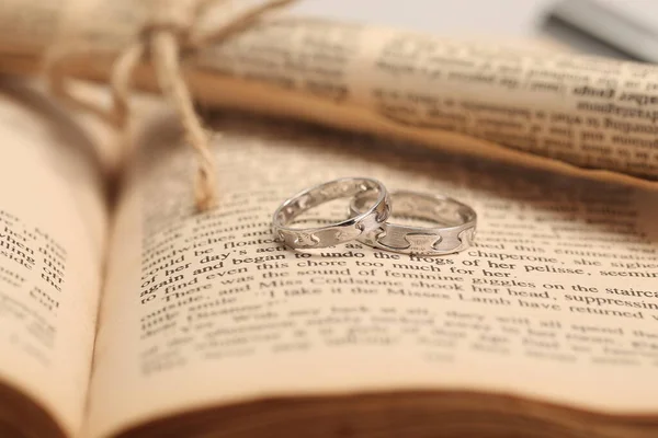 wedding rings and book on the table