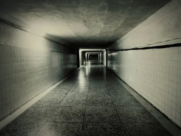 empty corridor with dark walls and a tunnel