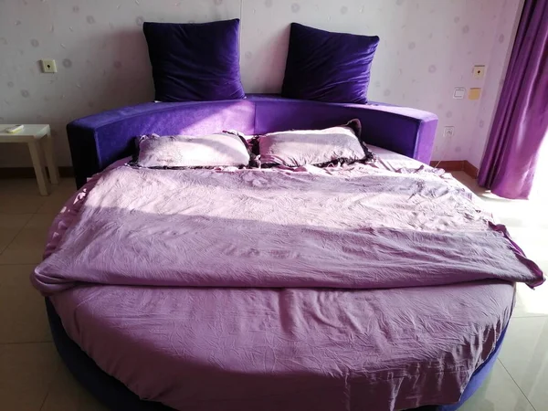modern bedroom interior with pink and purple pillows