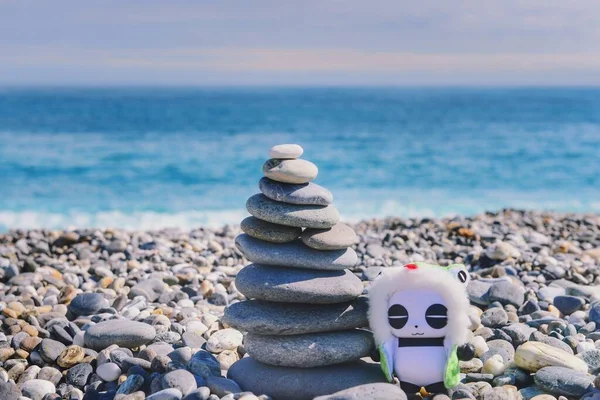 a man with a hat and a white towel on the beach