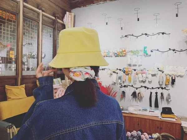 woman in a hat and glasses in a shop