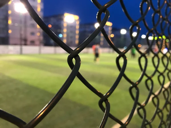 metal fence with a net and a chain