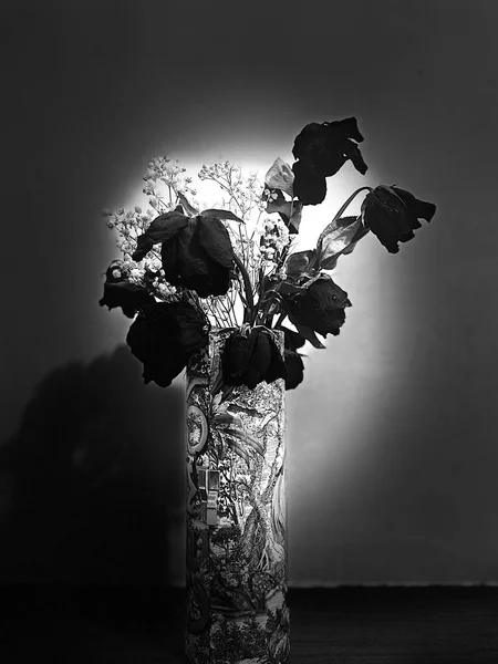 beautiful bouquet of roses in a vase on a dark background