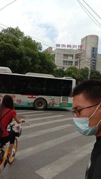 a man in a mask and a protective face masks on the street