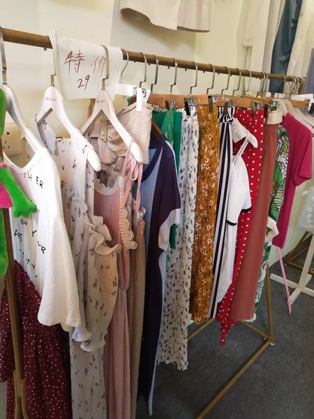 clothes store with hangers on the rack