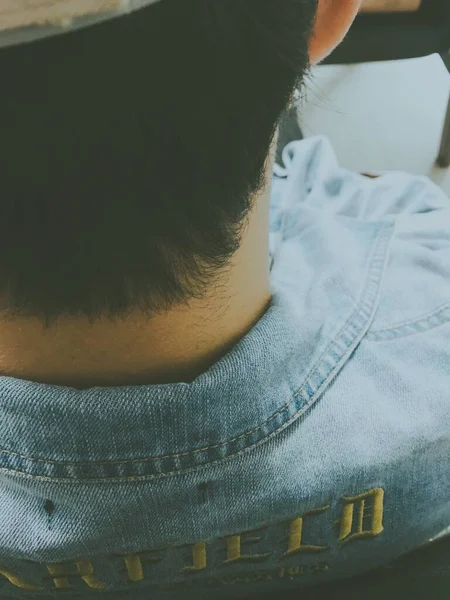 close up of a man in a leather jacket and jeans