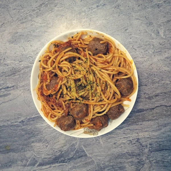 spaghetti with meat and vegetables on a plate