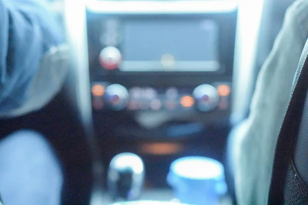 blurred image of people in the car