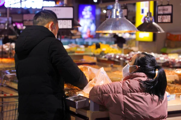 young woman in a shop with a lot of food