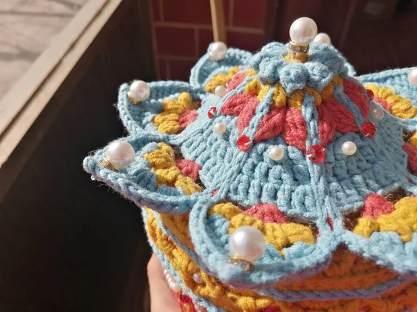 handmade knitted wool toy with a basket of yarn