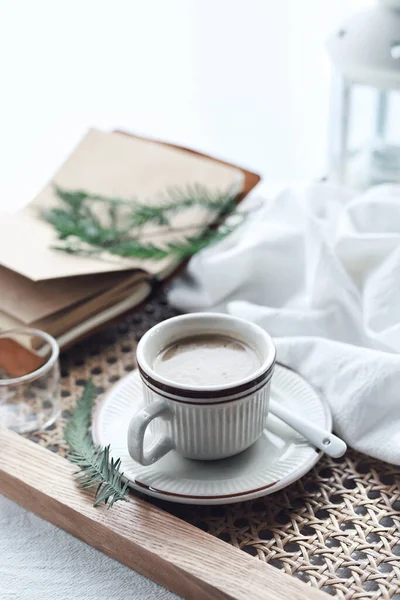 cup of coffee and a book on a white table
