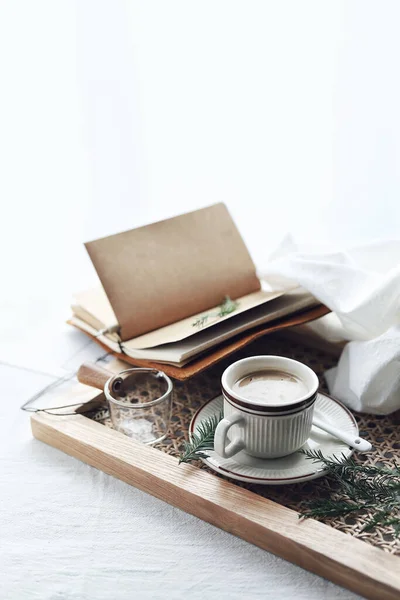 cup of coffee and a book on a white background