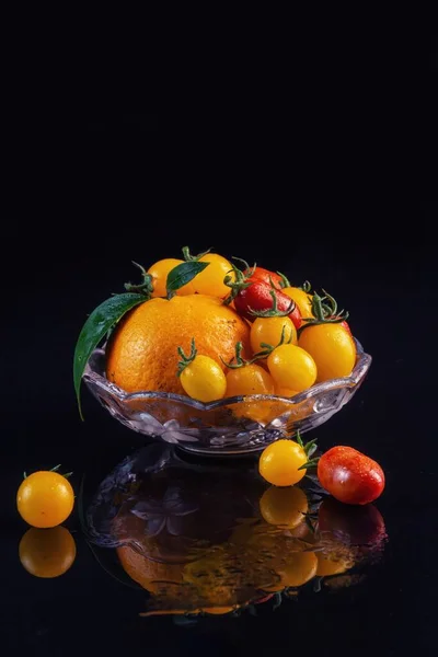 fresh fruits in a bowl on black background