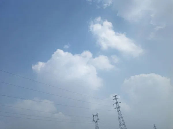 stock image high voltage power lines and blue sky