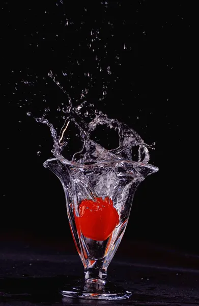 red water splash on black background