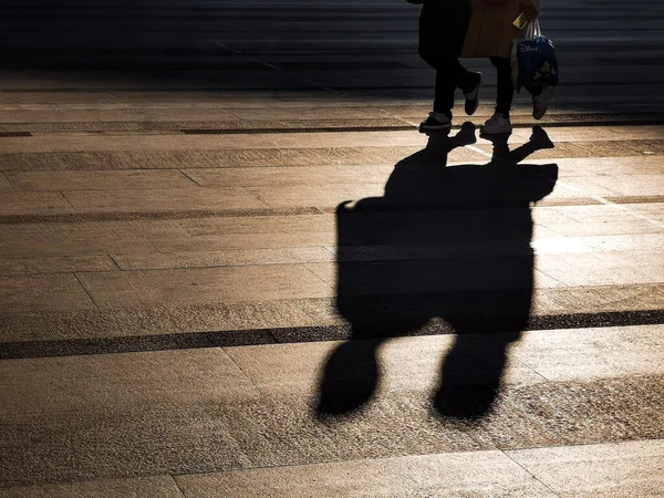 silhouette of a man walking on the street